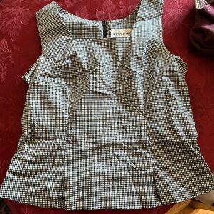 Cute top with zipper on back fitted and then flare at bottom